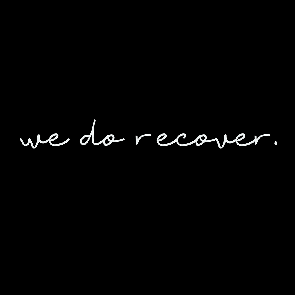 White handwritten text on a black background reading “we do recover.” representing healing, resilience, and hope in recovery and self-growth