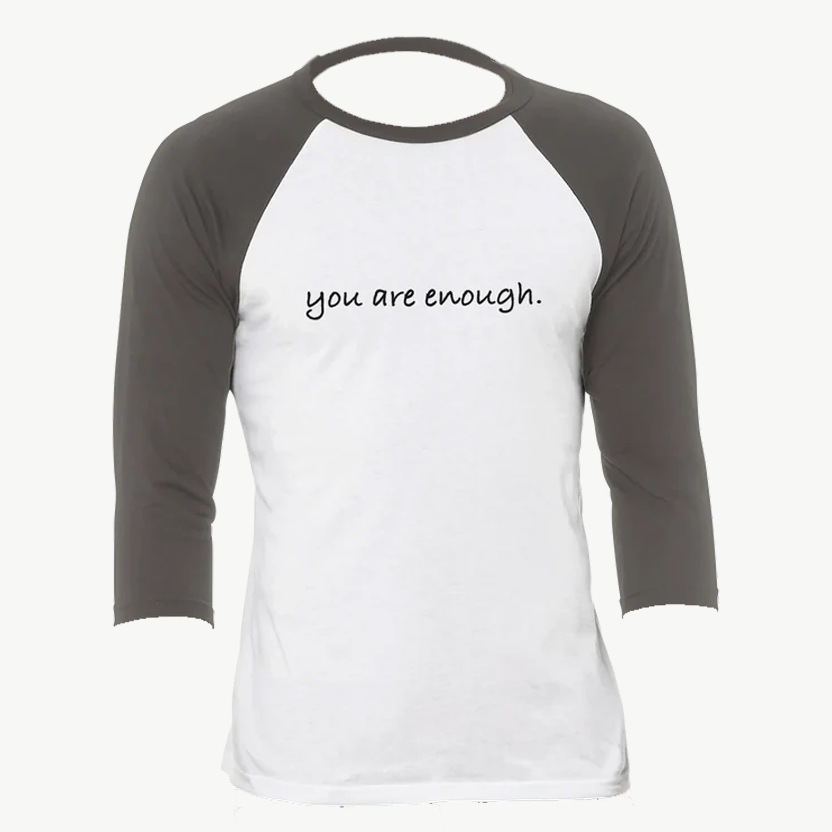 White and gray raglan shirt featuring the uplifting phrase "you are enough." A minimalist and empowering design promoting self-love, confidence, and positivity—perfect for everyday motivation or gifting inspiration.