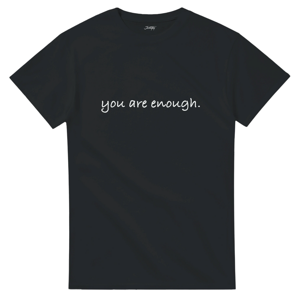 Minimalist black T-shirt with white handwritten text reading “you are enough.” An inspirational quote tee reminding you of self-worth and positivity, available in multiple dark colour options.